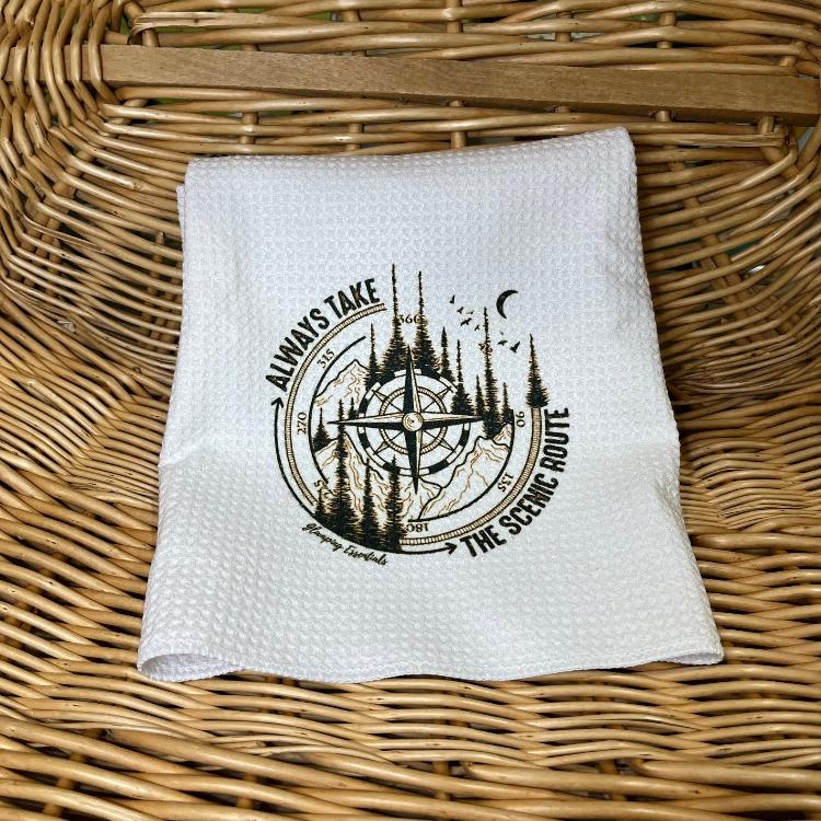 The contents of the Spring 2024 Glamping Box: White waffle 'Always take the scenic route' tea towel