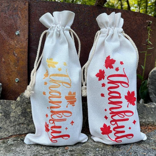 Two canvas wine bags, with thankful on the front in fall colours