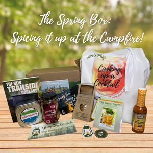 A collection of items from the Spring Box: The New Trailside cookbook, an InstaPit, Vegetarian chili from Recipes in a Jar, Spices, hot sauce, a fancy apron, drink recipe, stickers and more!