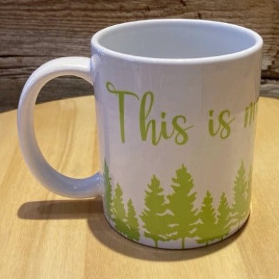 Our white "This is my cottage / camping mug" 12oz mug.  White mug with green lettering that says "This is my" over a green forest.  The rest of the mug would say "camping mug" or "cottage mug" depending on which you choose.  Very cute for camping or the cottage.