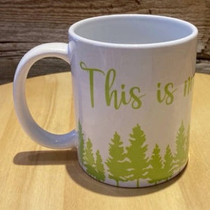 Our white "This is my cottage / camping mug" 12oz mug.  White mug with green lettering that says "This is my" over a green forest.  The rest of the mug would say "camping mug" or "cottage mug" depending on which you choose.  Very cute for camping or the cottage.