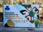 Load image into Gallery viewer, From the May Glamping Box, this is a picture of a box of chocolate and vanilla Girl Guide cookies.  &quot;Everything she wants to be.&quot;
