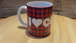 Load and play video in Gallery viewer, A quick video of our &#39;I Heart Coffee&#39; ceramic 12 oz Glampy mug.  It is spinning slowly so that the words &quot;I Heart Coffee&quot; can be read.  The words are printed in white on a buffalo check (red and black) background.
